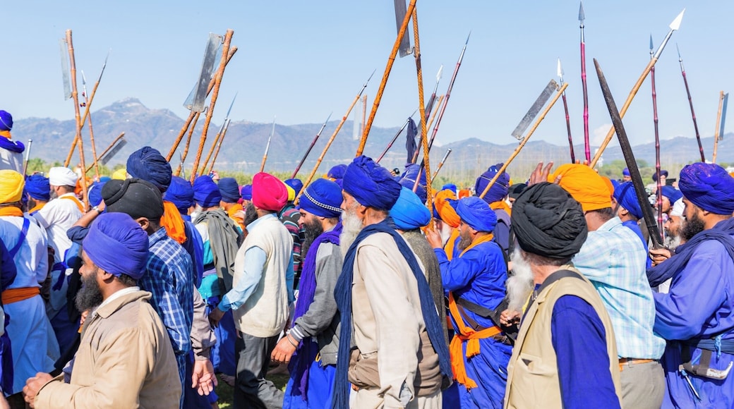 #Blue. This image is from Hola Mohalla, a tradition of annual celebration of valour started by Sikh Guru, Guru Gobind Singh. This celebration happens in Anandpur Sahib, a small town in the northern Indian state of Punjab. The procession of sharp-edged weapon wielding Nihang Sikhs is completely peaceful. The show-stopper of this festivity is show riding - daredevil riders ride 3 or even 4 galloping horses standing upright holding the reigns in their mouth.
