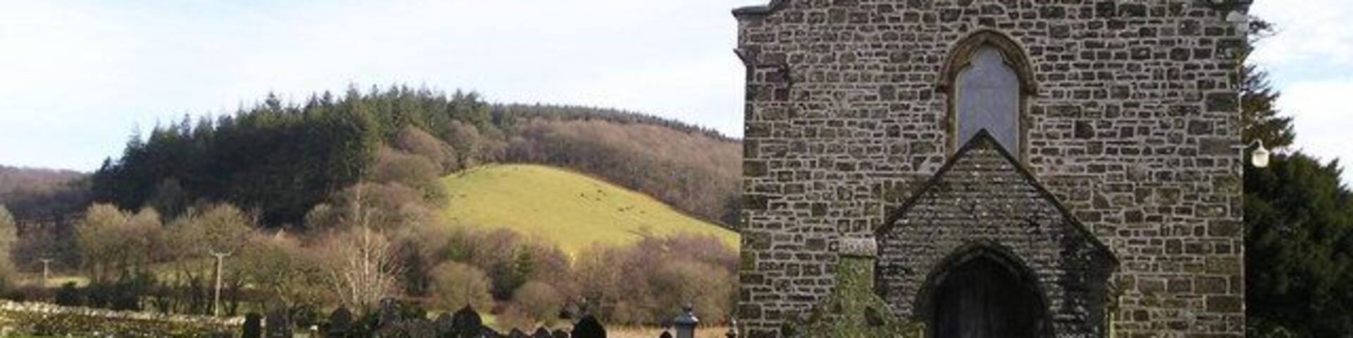 Eglwys Llanllawddog Rural church in Llanllawddog with a well kept graveyard but a dwindling congregation. In the background you can see wooded hills, part of the extensive Brechfa Forest.