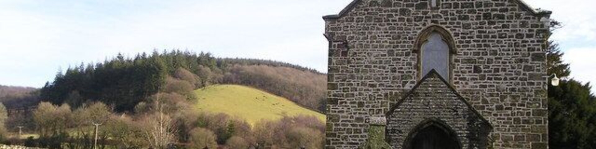 Eglwys Llanllawddog Rural church in Llanllawddog with a well kept graveyard but a dwindling congregation. In the background you can see wooded hills, part of the extensive Brechfa Forest.