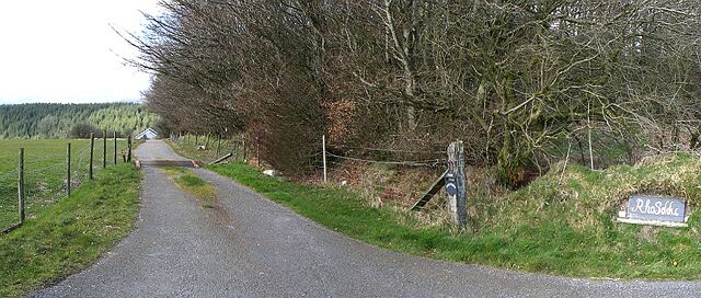 A rural road with a sign reading "Rudolf".