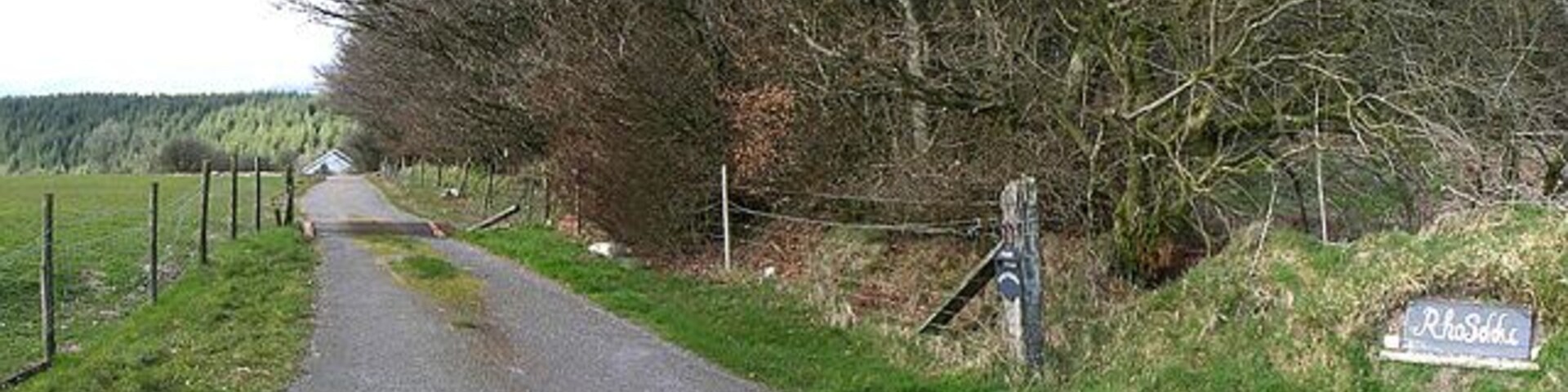 A rural road with a sign reading "Rudolf".