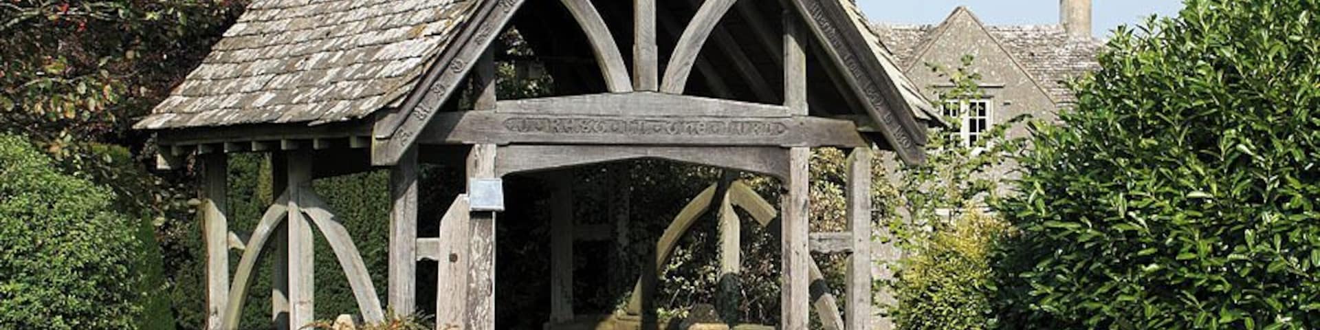 Lychgate, St Andrew's Church, Miserden According to the inscription, this lychgate was given in memory of Maria, the wife of the Rev. W Yarnton Mills, rector of Miserden from 1842 to 1870. It was built in 1900. The old rectory is just visible behind the lychgate.