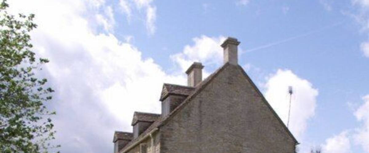 Farmhouse, Miserden Church Farm, the end wall of which overlooks the churchyard at Miserden.