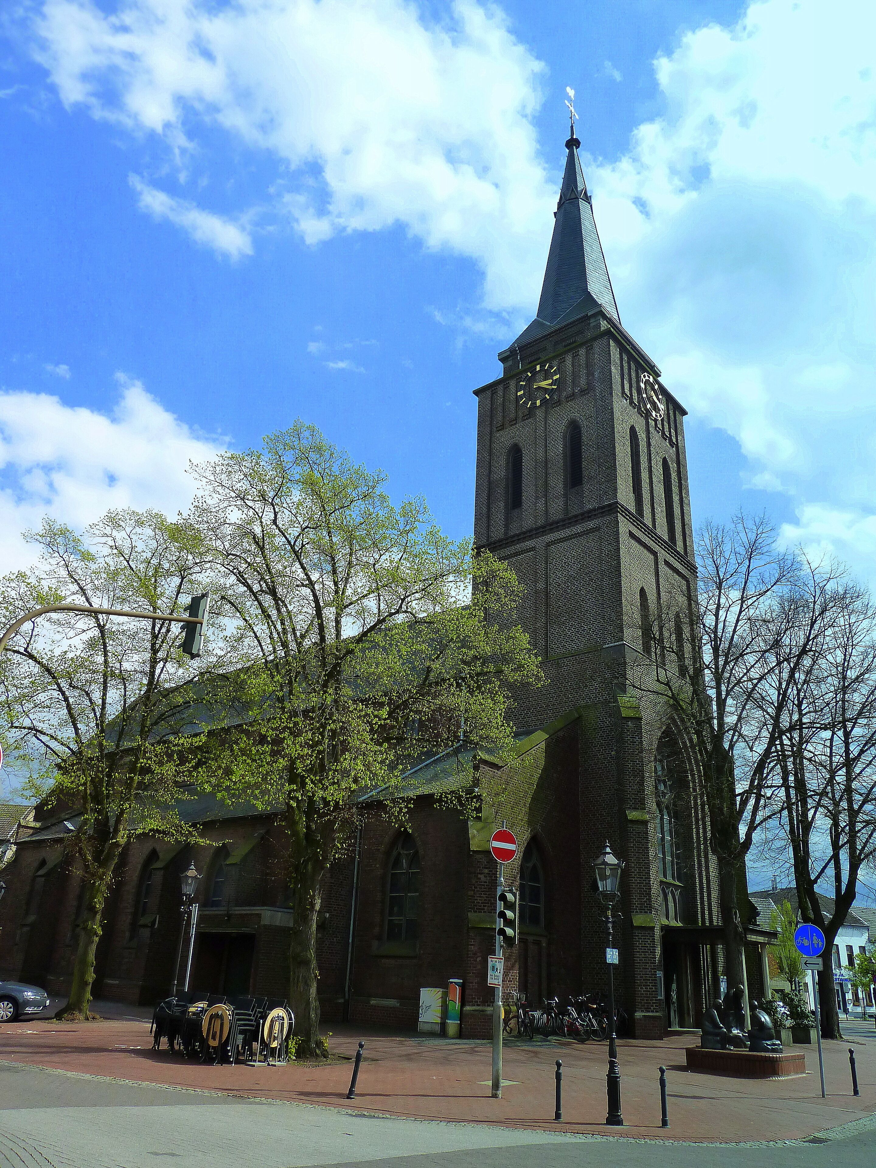 A historic church with a tall tower and a clock.