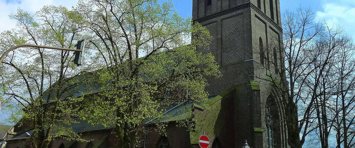 A historic church with a tall tower and a clock.