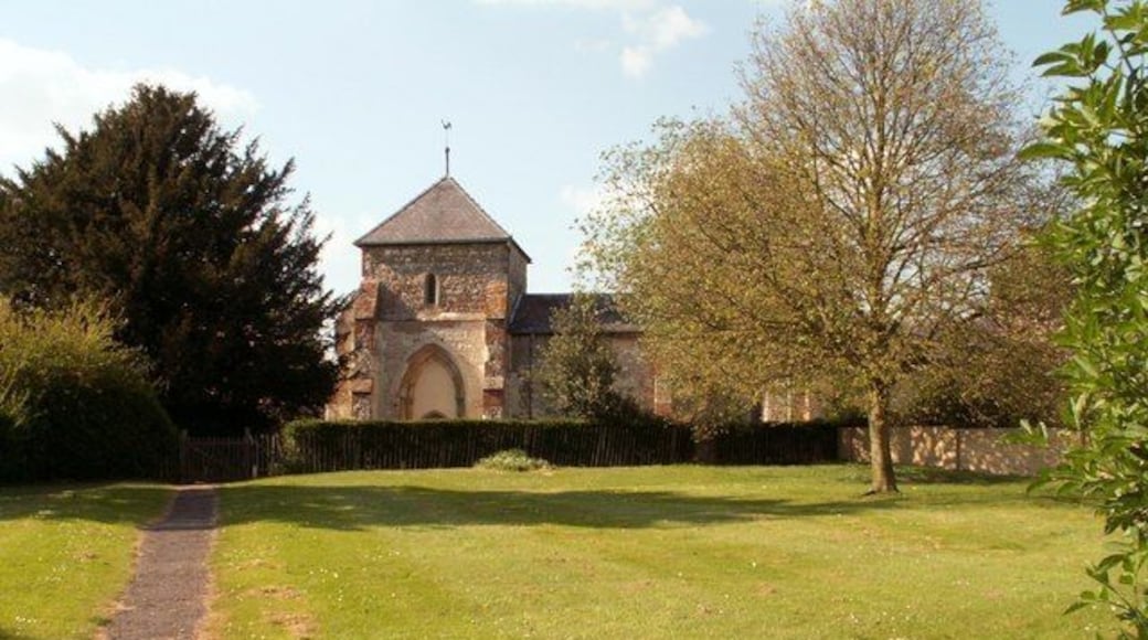 St. Guthlac: the parish church of Astwick The exterior of this church shows that it was once a cruciform church. The arch over the entrance was once the opening into the south transept. This is the view from the roadside gate.