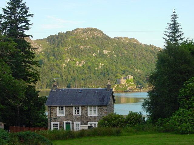 Tioram Cottage on [{w:Eilean Shona]], Inner Hebrides, Scotland, with w:Castle Tioram in the background. Tioram is Scottish Gaelic for "dry", but in this case, it derives from Castle Tioram on the opposite shore, which takes its name from the eilean tioram or "dry island" (i.e. tidal) on which it is situated.