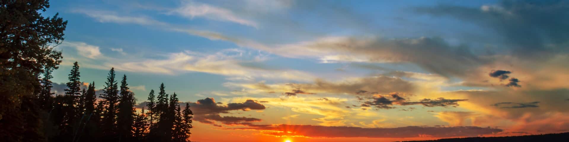 lake and red sunset glow, sun rays, black silhouettes of trees and reflection