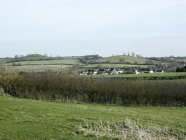 Rolling hills, a rural landscape, and scattered houses.