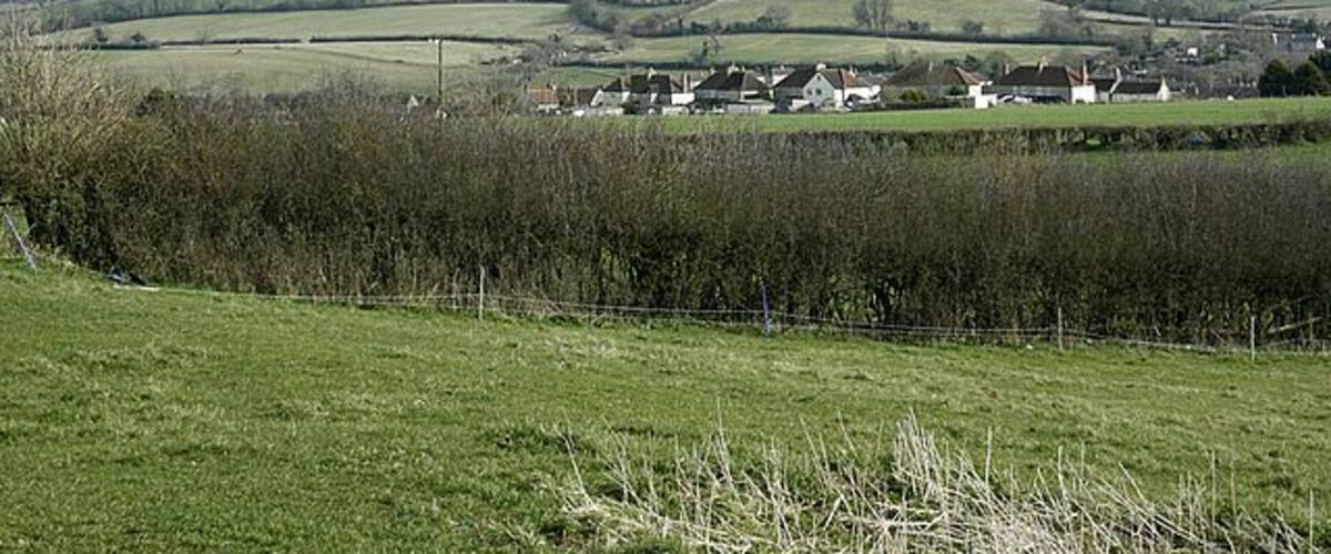Rolling hills, a rural landscape, and scattered houses.