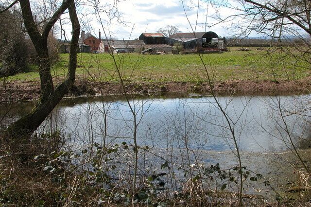 Farm at Mere Pool, Allensmore. Here the farm is viewed from a small pool to the north. Mere Pool is a much larger pool just to the south of the farm.