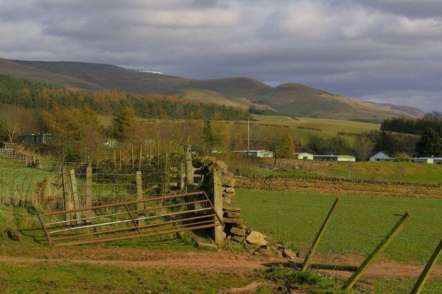 View Over Fields to Holiday Park. Note there is still a small amount of snow on the top of Cross Fell on the horizon.