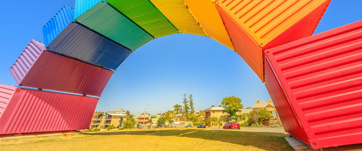 Fremantle travel welcome. Rainbow sea container in Fremantle Port near Perth, Western Australia. Homosexuality and universal symbol of hope concept. Sunny day with blue sky. Copy space.