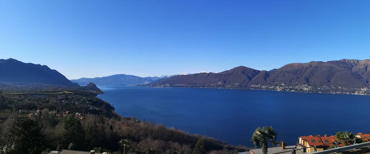 A lake surrounded by mountains and a town.