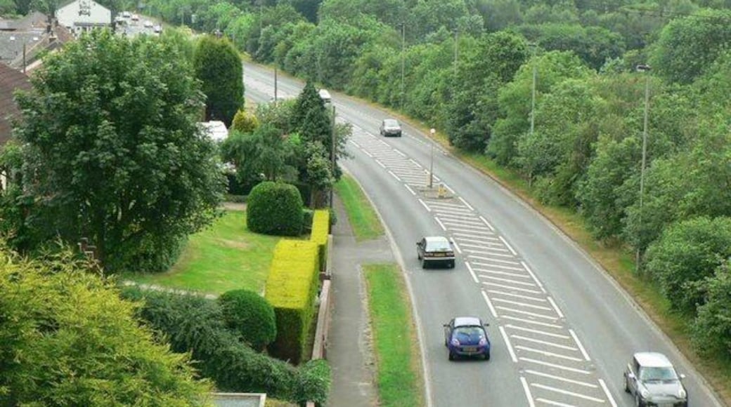 Denby Dale Road, Calder Grove. Looking down from the disused railway viaduct which crosses the road, and a railway line. The white building at the left is The British Oak, a pub at the corner of Blacker Lane. See also 193164