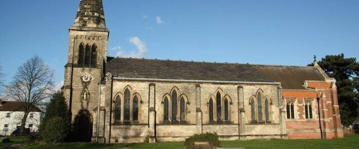 A church with a tall spire and arched windows.