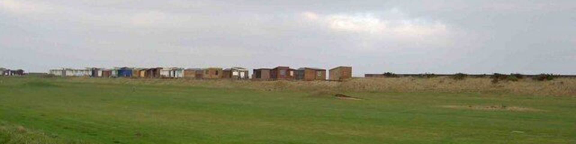 Sandilands golf course From Roman Bank, note the beach huts on the horizon.