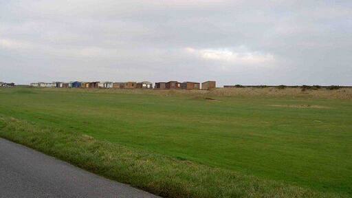 Sandilands golf course From Roman Bank, note the beach huts on the horizon.