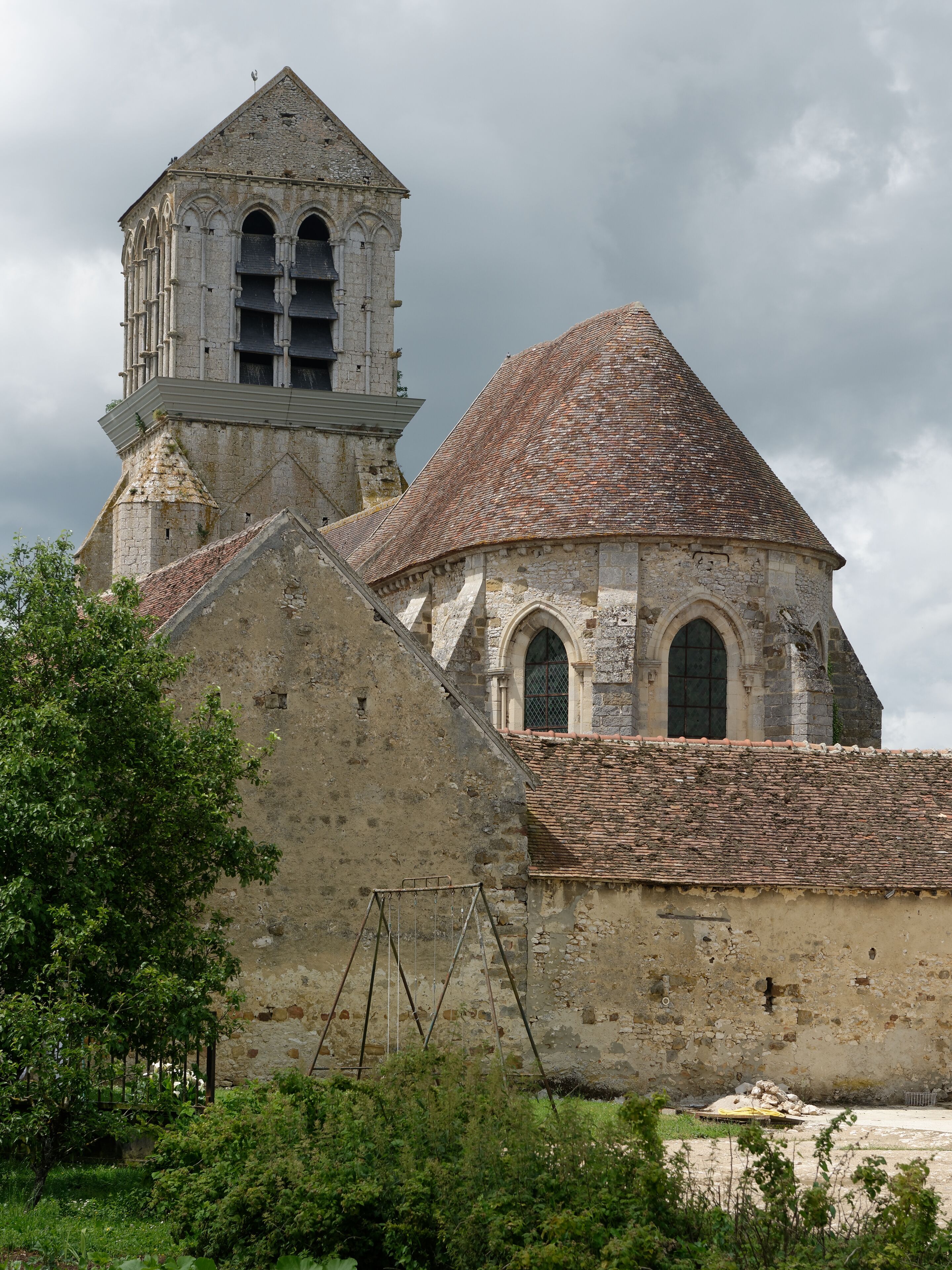 A historic church with a bell tower and a tiled roof.