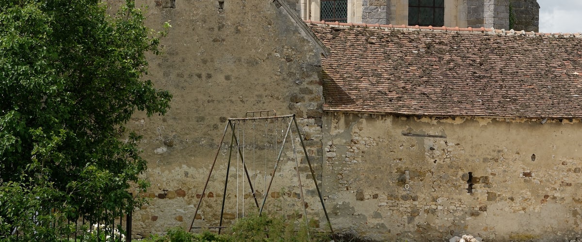 A historic church with a bell tower and a tiled roof.