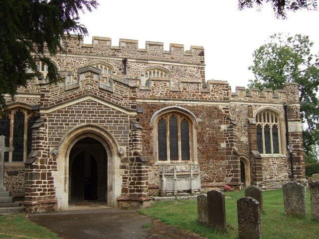 St Nicholas, Tingrith : Porch, South Aisle & Nave. The tower of this church is undergoing maintenance, while the clean contrasting mortar and stones on this part of the building suggest perhaps that this section has already had some work performed on it.