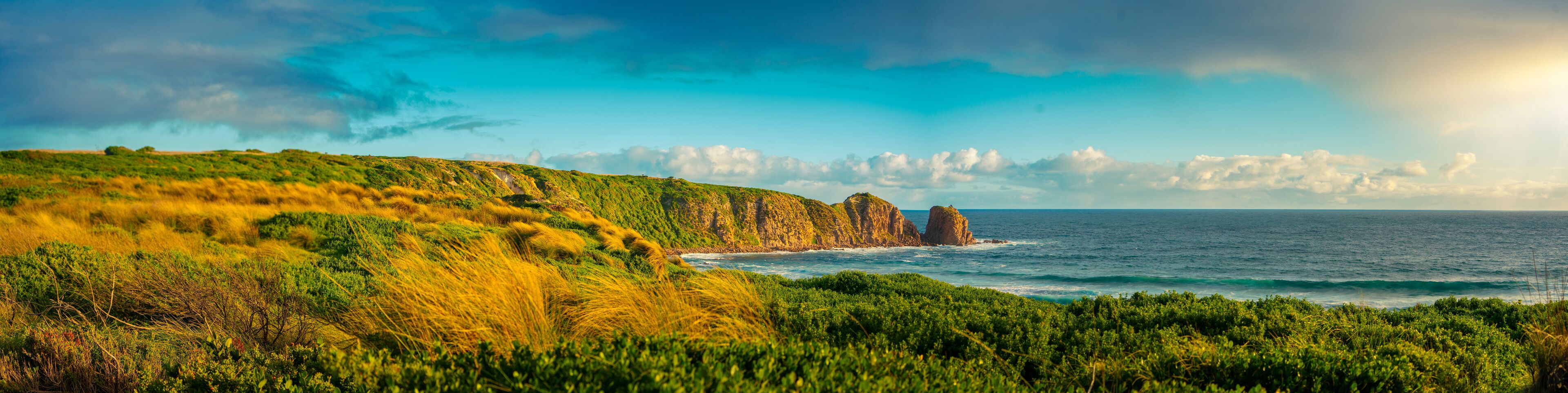 Panorama of Cape Woolamai beach showing the Pinnacles rock formation at sunset, Phillip Island, Australia