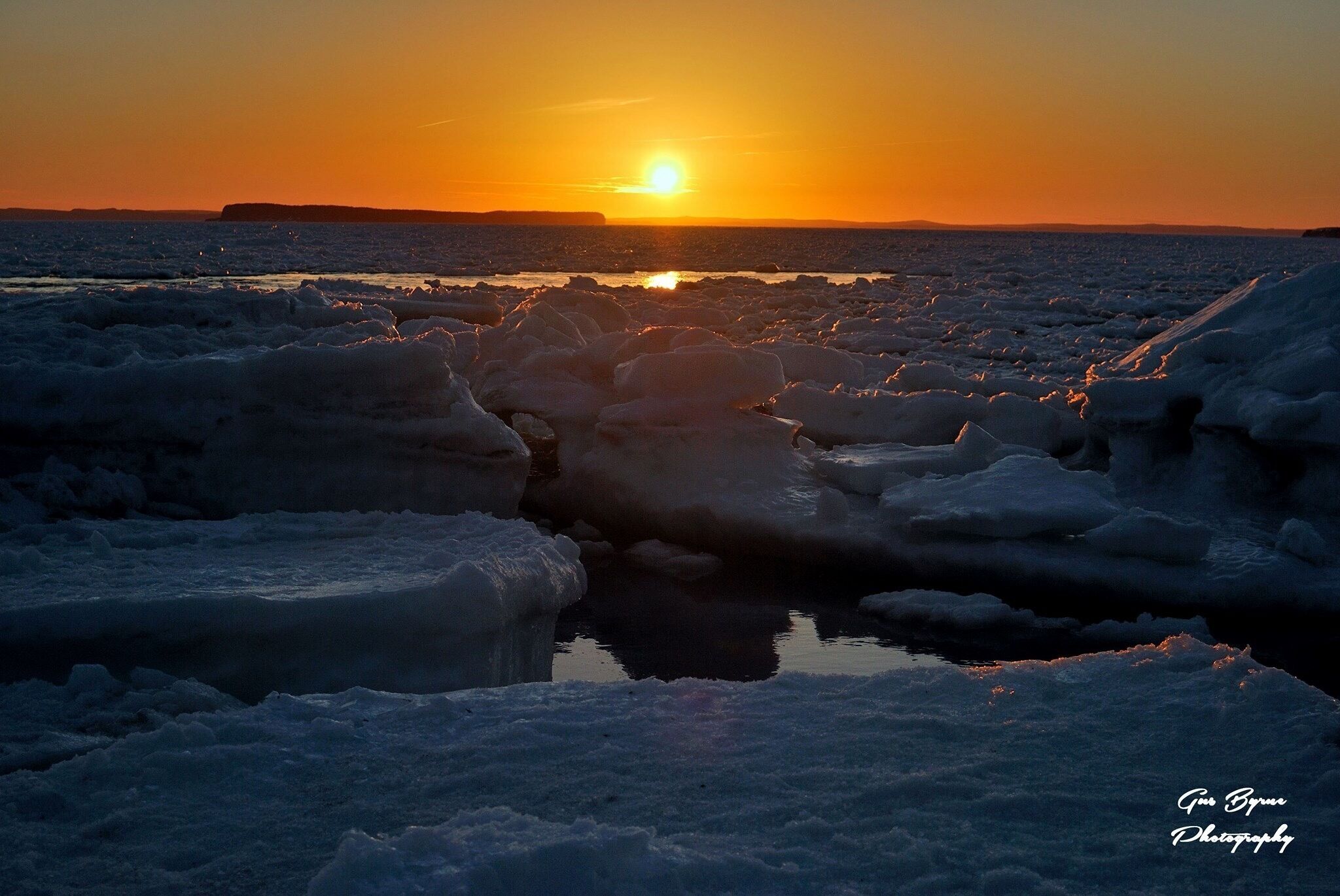 An amazing picture taken by my husband Gus Byrne. Sunset on ice filled beach