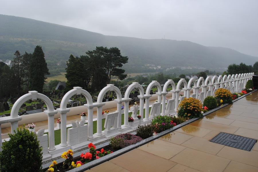 #Details! .The Aberfan disaster was the catastrophic collapse of a colliery spoil tip in the Welsh village of Aberfan, near Merthyr Tydfil, that killed 116 children and 28 adults on 21 October 1966. The collapse was caused by the build-up of water in the accumulated rock and shale tip, which suddenly slid downhill in the form of slurry.
In the cemetery side by side stands and overwhelming array of arches - each one a grave to those who passed that fateful day.
It is beautiful and peaceful - almost heavenly - worthy of a visit....I felt initially uncomfortable to take photos but the beauty of it overwhelmed me and will live with me forever.
#Photo Details Sweepstake