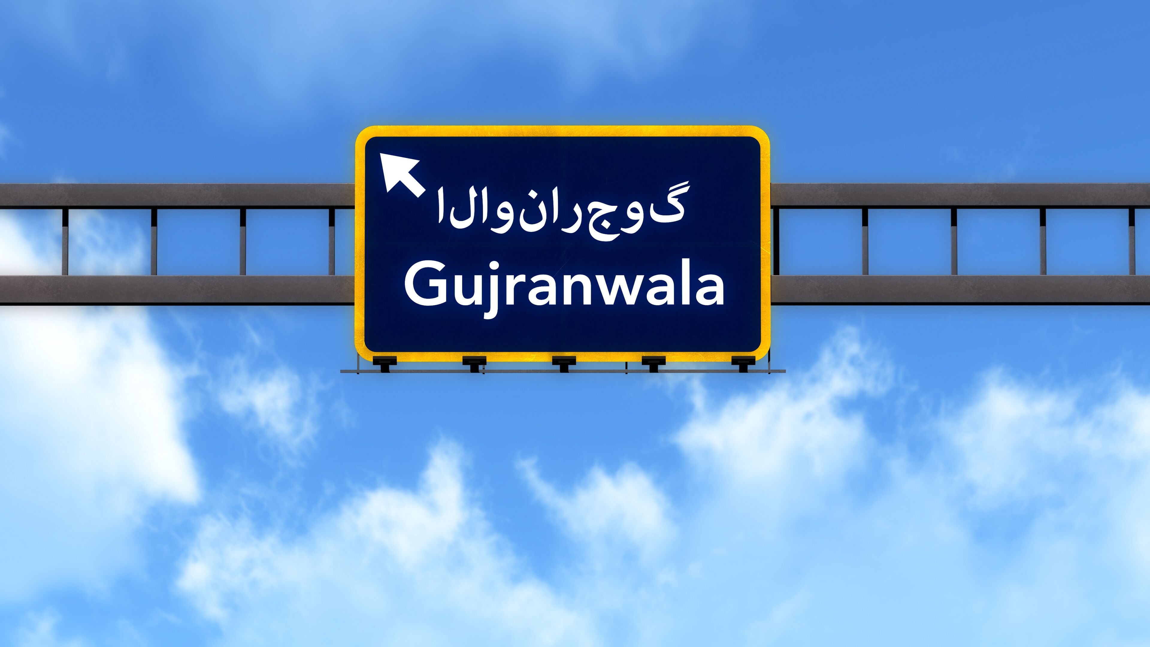 A road sign with the text "Gujranwala" and an arrow pointing to the right.