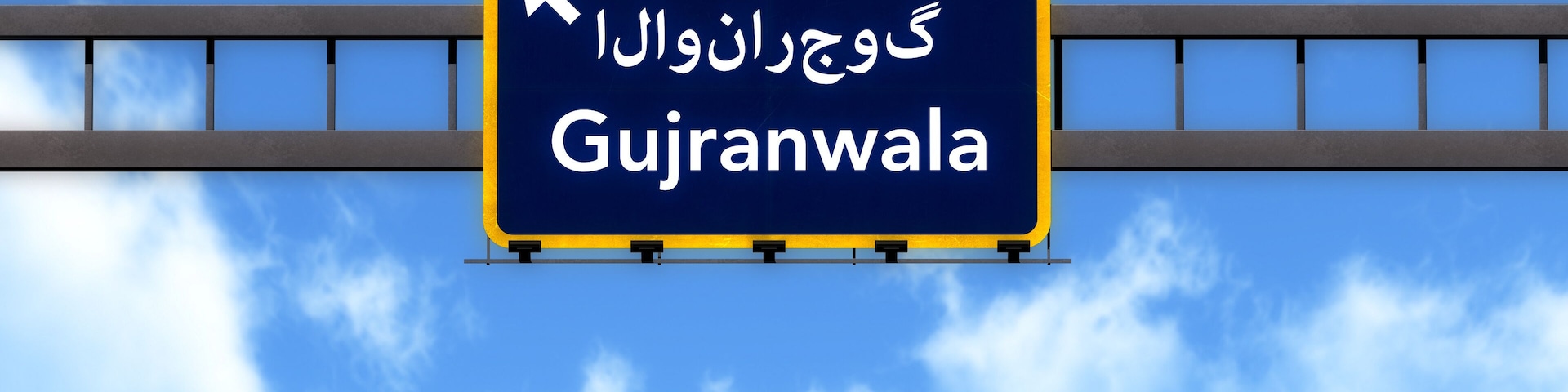 A road sign with the text "Gujranwala" and an arrow pointing to the right.