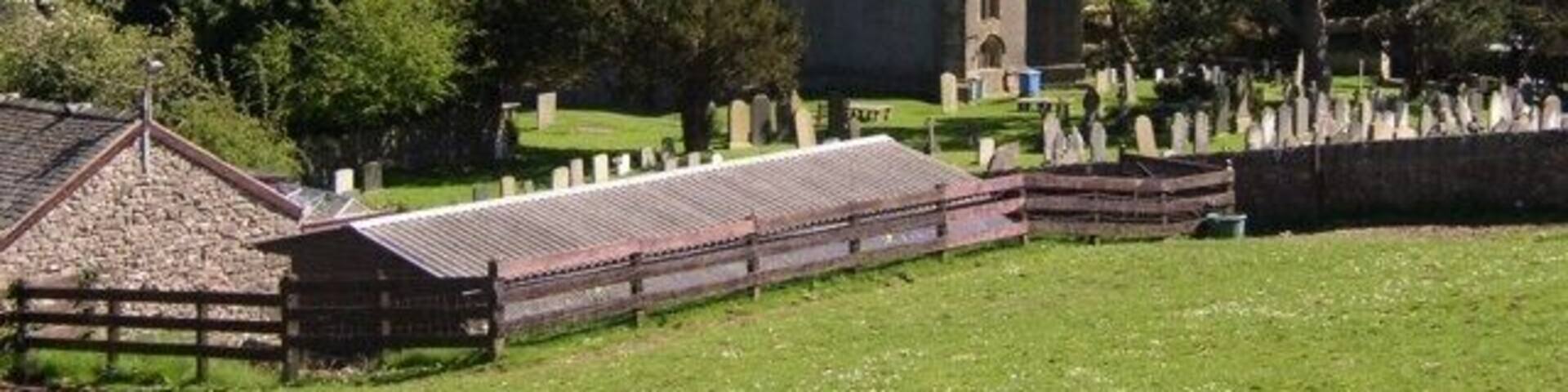 St Oswald's Church, Warton. The oldest part is the 14C south chapel. The tower, chancel and north arcade are in Perpendicular style, so were built in the 15C or 16C. The font was made in 1661 and has a delicately patterned lead lining.