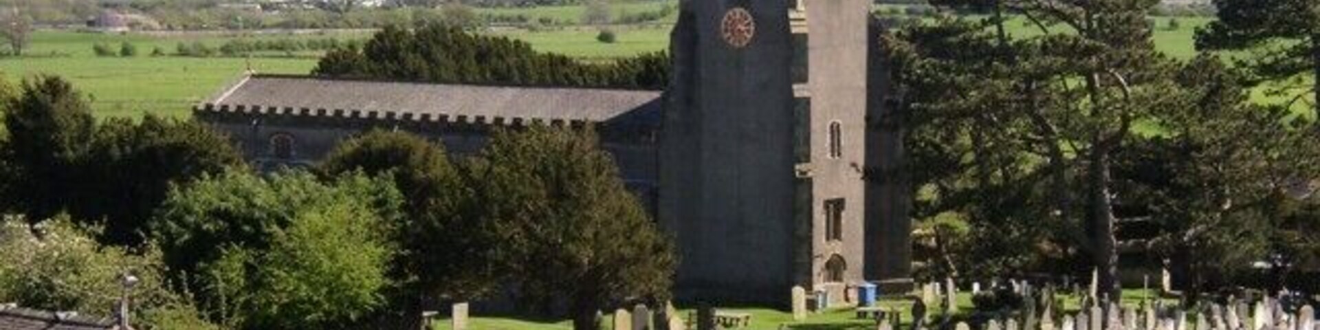 St Oswald's Church, Warton. The oldest part is the 14C south chapel. The tower, chancel and north arcade are in Perpendicular style, so were built in the 15C or 16C. The font was made in 1661 and has a delicately patterned lead lining.