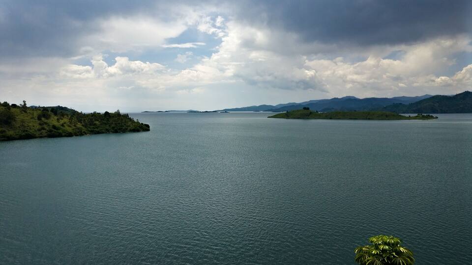 A large body of water with islands and mountains in the background.