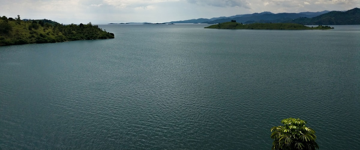 A large body of water with islands and mountains in the background.