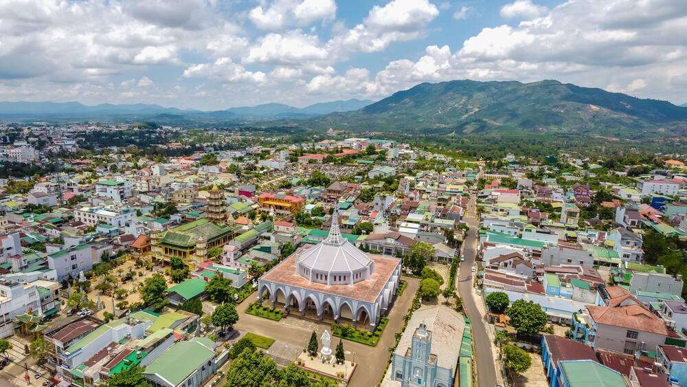 Aerial view of ancient Phuoc Hue pagoda is next to Bao Loc church on summer's day in Bao Loc, Vietnam, peaceful small town located on the plateau Di Linh, Lam Dong province.