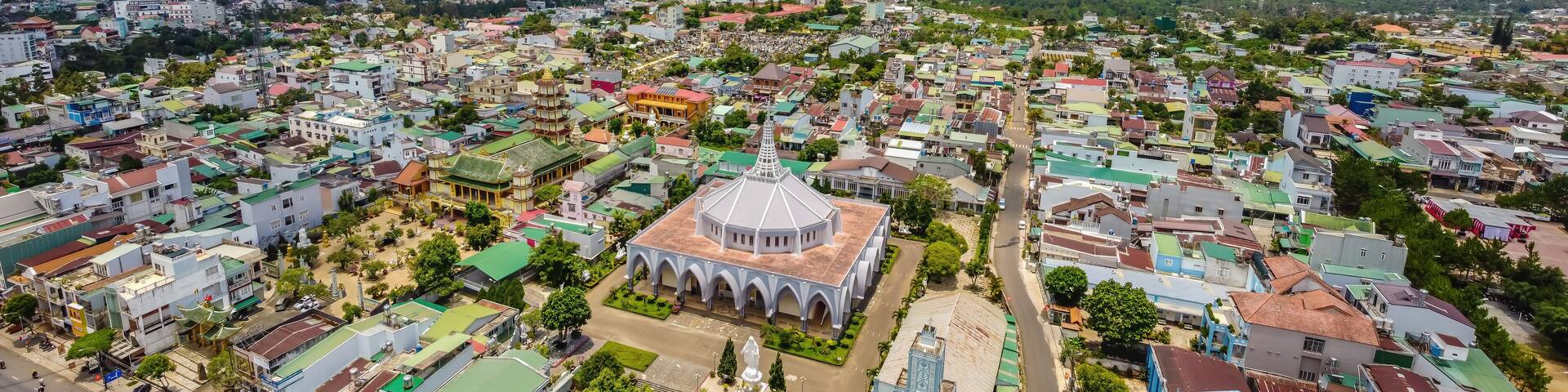 Aerial view of ancient Phuoc Hue pagoda is next to Bao Loc church on summer's day in Bao Loc, Vietnam, peaceful small town located on the plateau Di Linh, Lam Dong province.