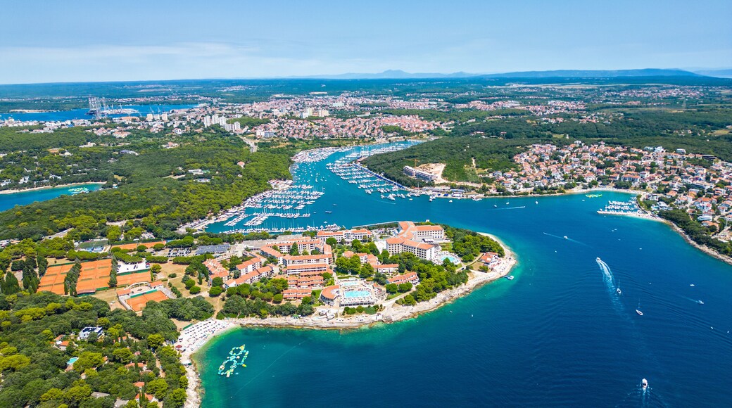 Aerial view of Pješčana Uvala near Pula, Croatia – beachside village, marina, turquoise sea and lush green coastline