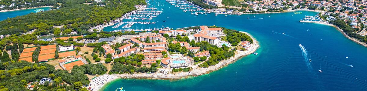 Aerial view of Pješčana Uvala near Pula, Croatia – beachside village, marina, turquoise sea and lush green coastline