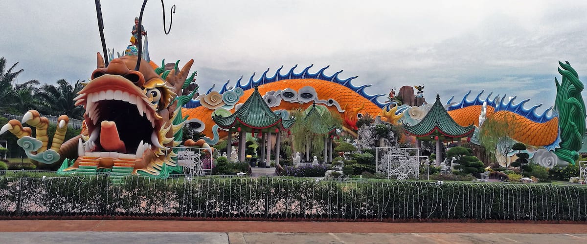 A dragon-themed park with large dragon sculptures and traditional Chinese architecture.