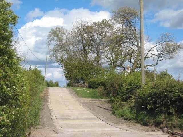 The road to Horn's House and Fulforth Illustrating a robust approach to the construction of farm roads - massive elongated concrete blocks laid transversely across the road.