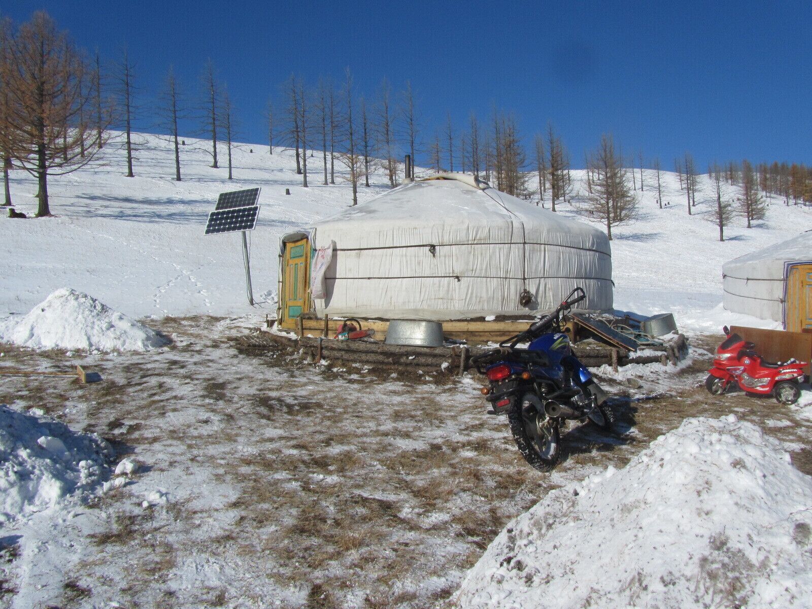 The typical ger site (this one in Arkhangia aimag) has about three gers of extended family; and some of the trappings of modern life such as solar panels and motorbikes. The door will always face south.