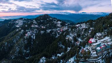 A snow-covered mountainous village with buildings and roads.
