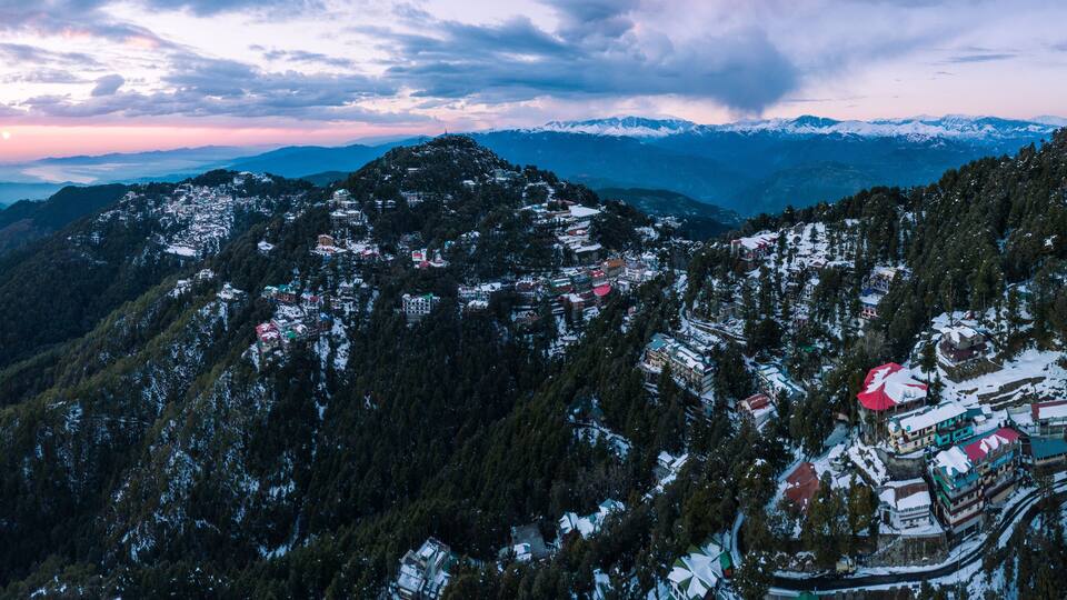 A snow-covered mountainous village with buildings and roads.