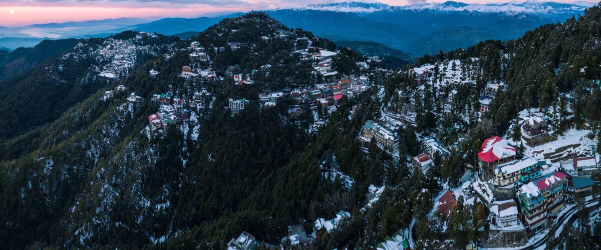 A snow-covered mountainous village with buildings and roads.