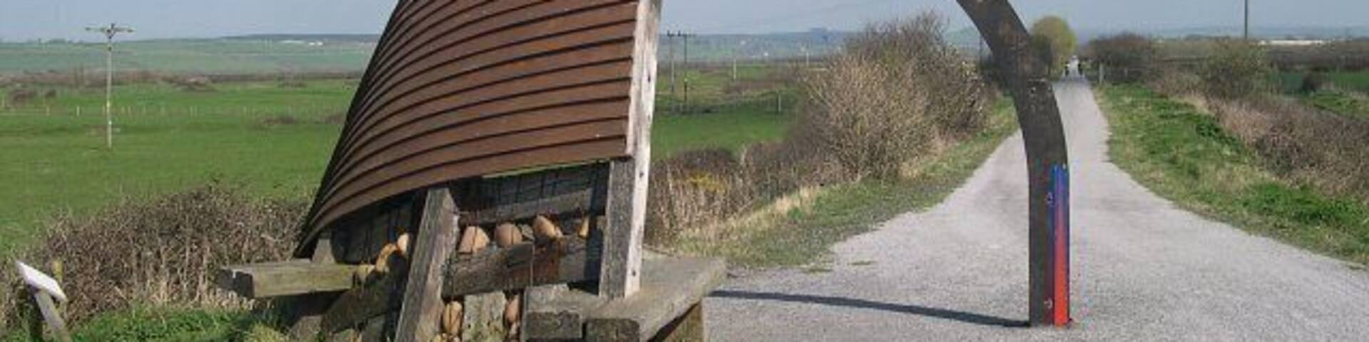 A "clinker built" shelter. On an exposed section of the cycle path around the Taw estuary.