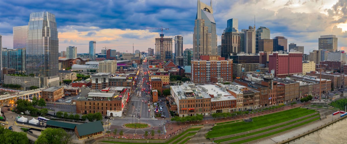A cityscape with modern skyscrapers, a river, and a mix of historic and contemporary architecture.