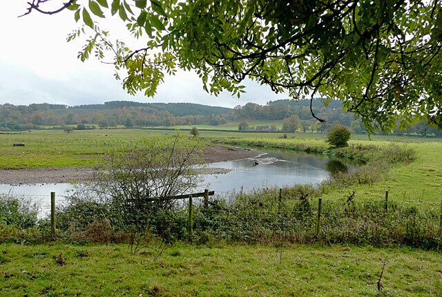 The River Trent near Colwich, Staffordshire The valley here is wide and flat bottomed; the river meanders a lot, and flooding is frequent after prolonged rain. The view is from the towpath of the Trent and Mersey Canal. There has been little rain in the last few weeks, and the river is very low.