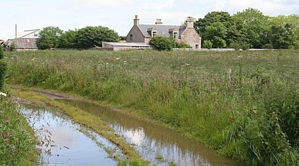 Nether Dallachy A flooded track reflects a spell of blue sky before the next downpour approaches from the west.