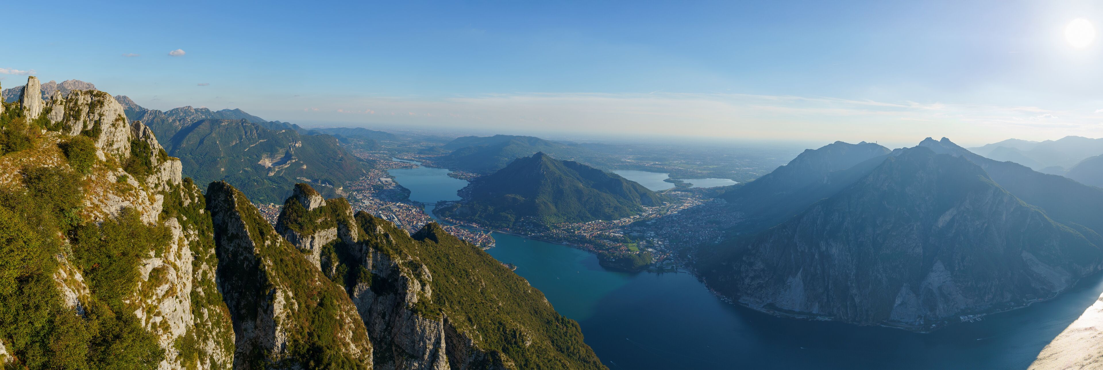 A mountainous landscape with a valley and a lake.