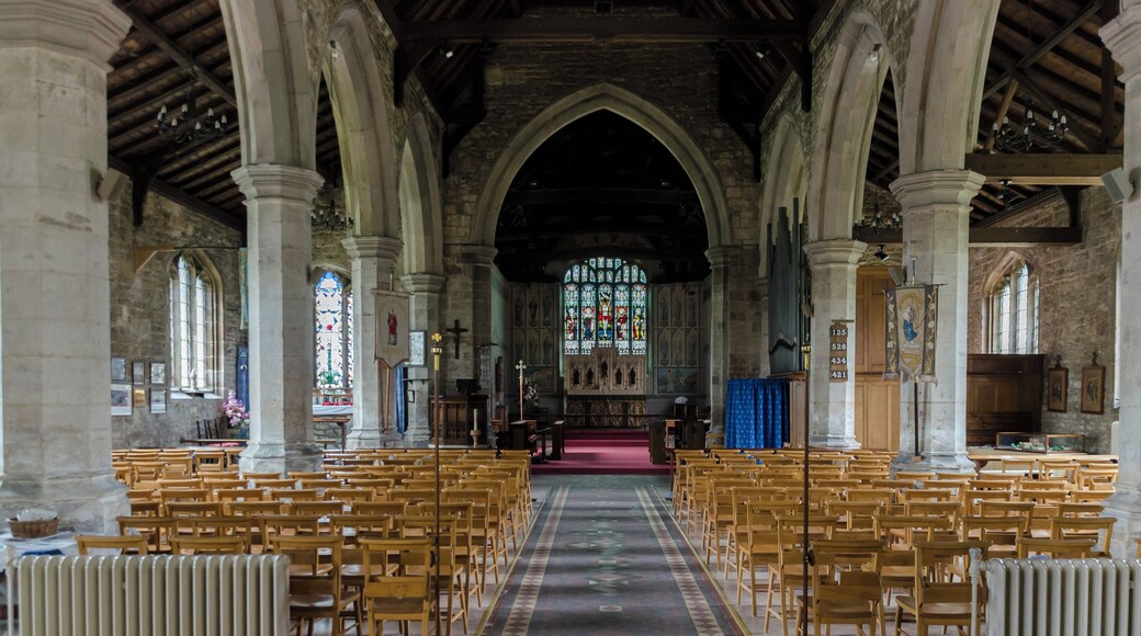 Interior. Note the painted chancel. The church was built around 1434, with restoration in the 1870s. It consists of a nave with aisles, western tower, chancel, and north porch. Some parts of the demolished Bardney abbey were used in the church. The tower dates from the late 15th century and has battlements topped with eight pinnacles. It has six bells. The north aisle of 5 bays is from the mid-to late 15th century, the south aisle is of the same date. The piers are octagonal. There is a 17th-century north porch with benches. The chancel is made of brick; Some say the same bricks used to build Tattershall Castle. Inside are murals of 1935 by A. Willets depicting Saints, and there are carved angels in the roof timbers. There is a 19th-century reredos and a 15th century piscina in the south wall. There is also a 14th century figure originally from Bardney Abbey. At the west end of the nave is an incised slab to Abbot Richard Horncastle, died 1508, and three painted wooden panels recording charitable donations. The font and choir stalls are 20th century. There are several architectural fragments from Bardney Abbey on display. The two manual organ is by Cousans. Restoration work was carried out in the 1870s at a cost of some ยฃ2500, during which the west end of the north aisle was formed into a baptistery. Further restoration was done in the late 1990s.